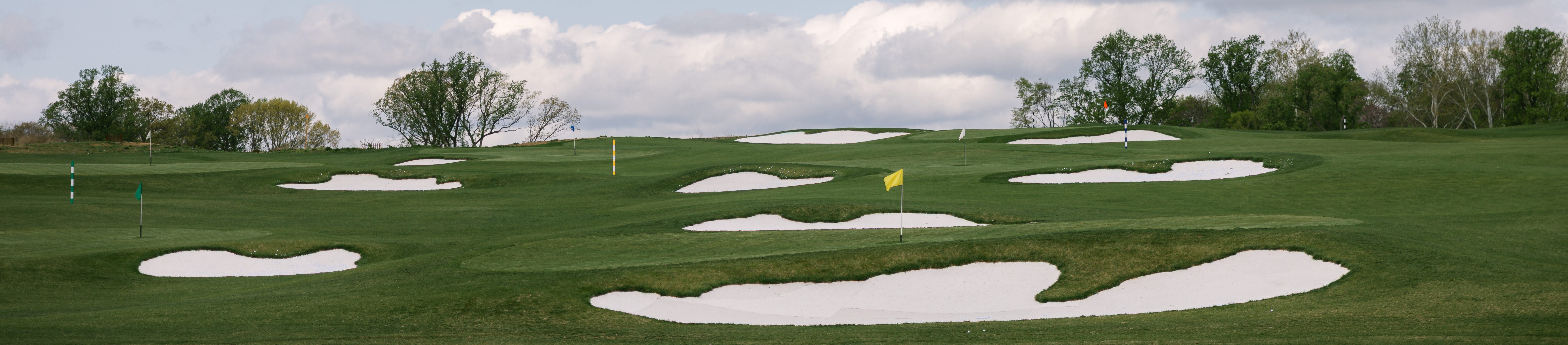 Image of golf ball on tee on grass.